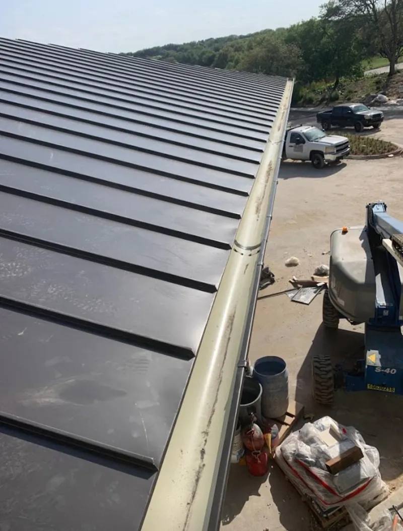 Standing seam panel and gutter detail on a metal roofing jobsite in Indian Harbour Beach
